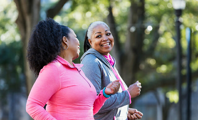 care aid and older woman walking