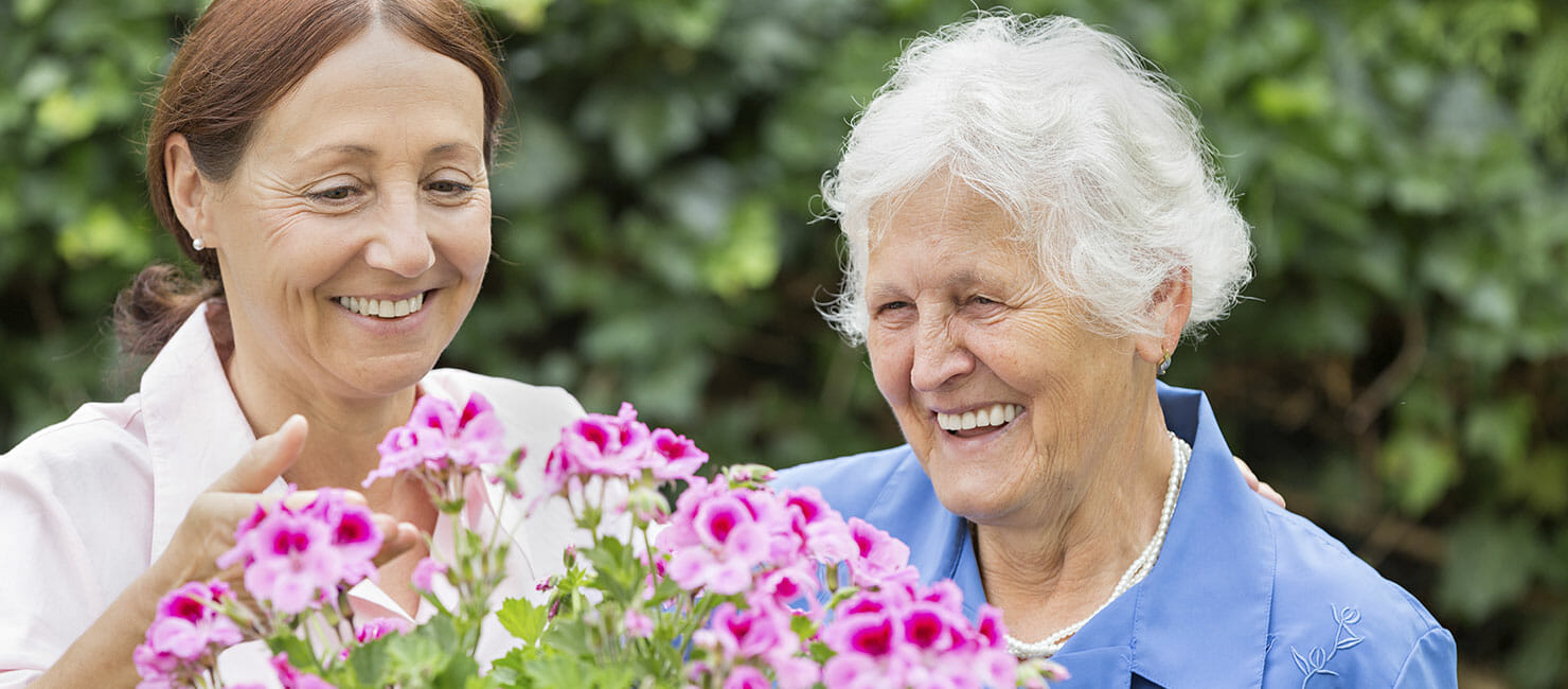 2 women with bright flowers